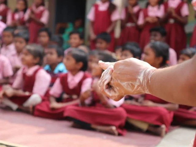 Children and adult demonstrating hygiene practices